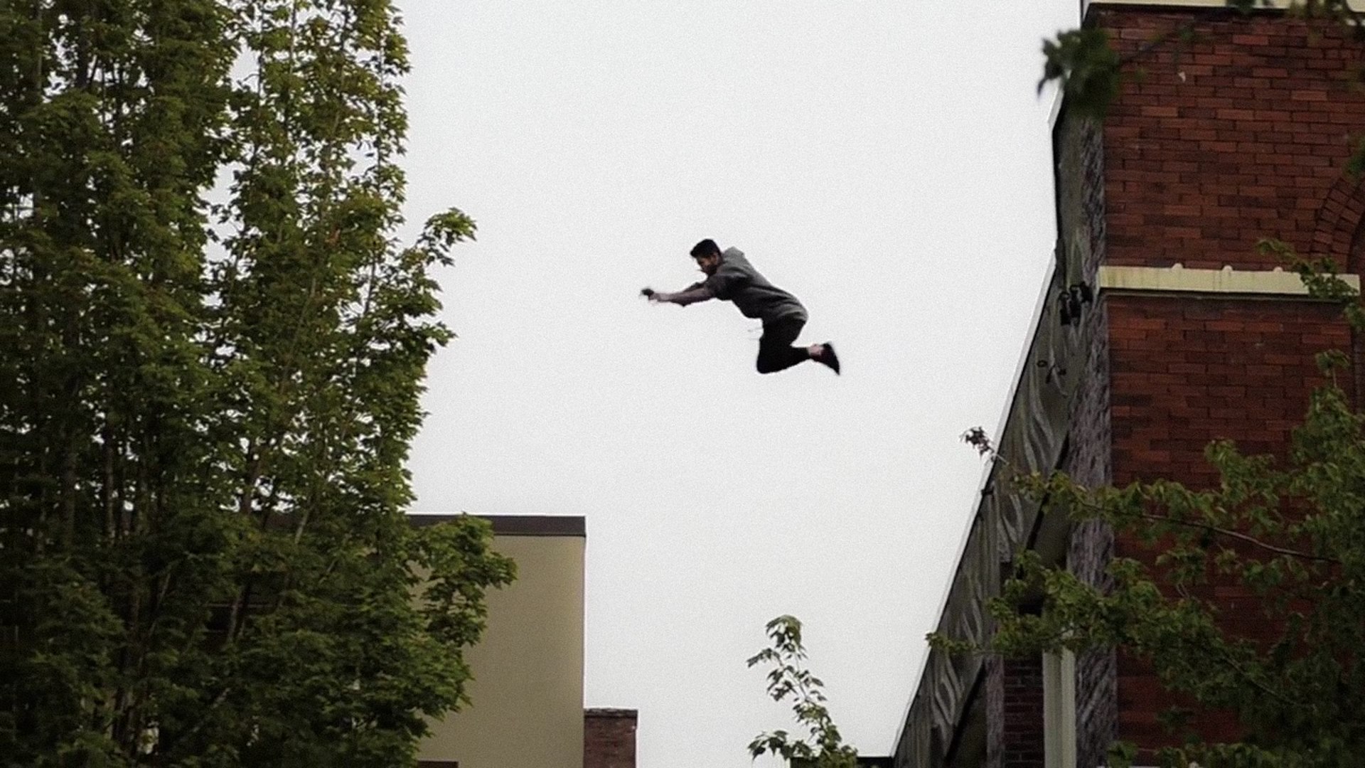 Archive photo: Michael Blackstone mid-jump between rooftops in Bellingham, WA
